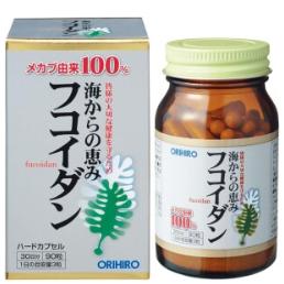 Pile of assorted Japanese supplement bottles and packages on a white surface